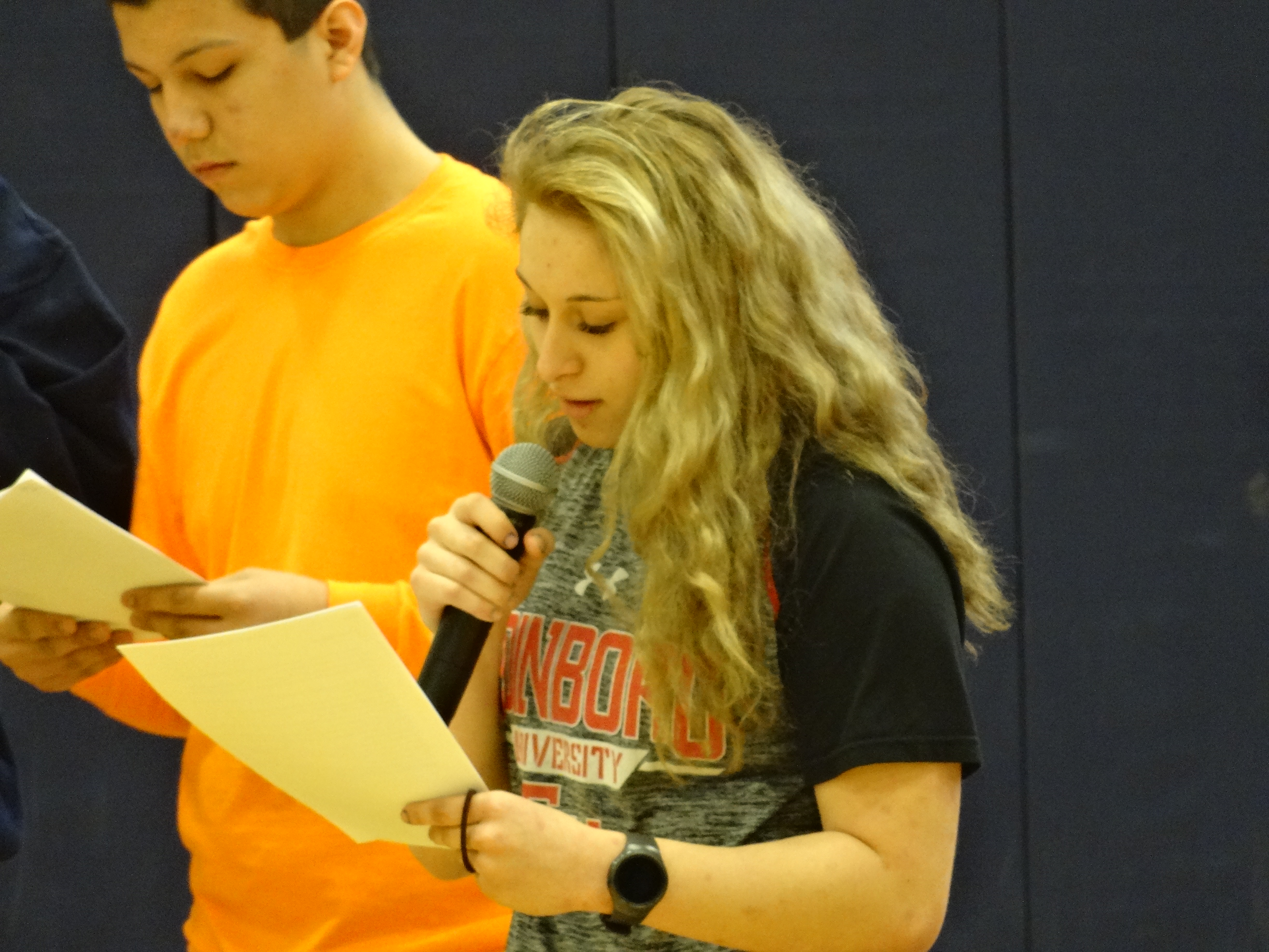 Brookfield High School student Marlaina Marek reads a biography of one of those slain in the Parkland, Fla., school shooting. Donnie Davis is behind her.