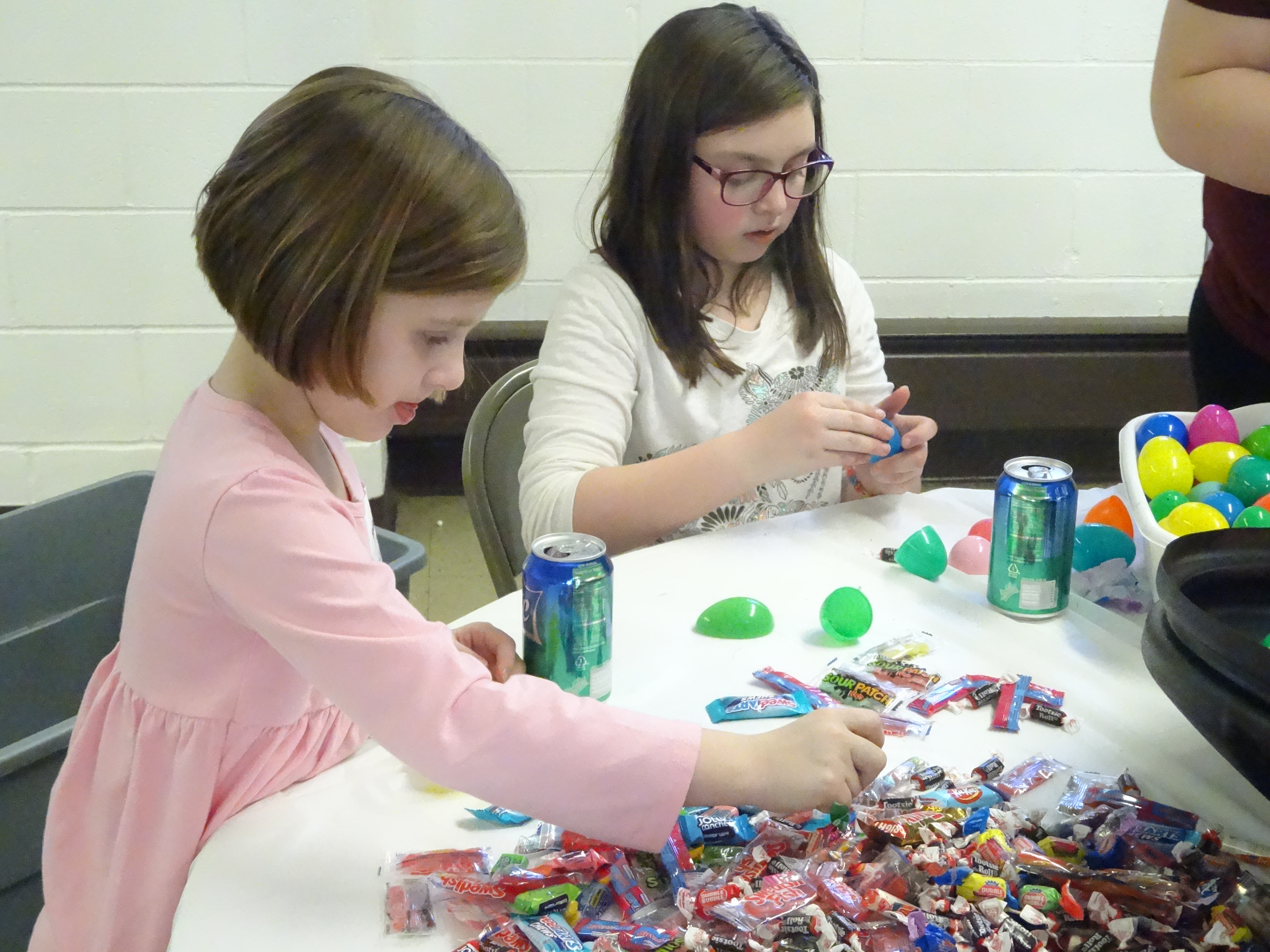 Hadleigh Fox, left, who is 7, and Hayleigh Fox, 10, stuff Easter eggs for in preparation for Six Fourteen Church's Easter egg hunt. The girls live in Hubbard.