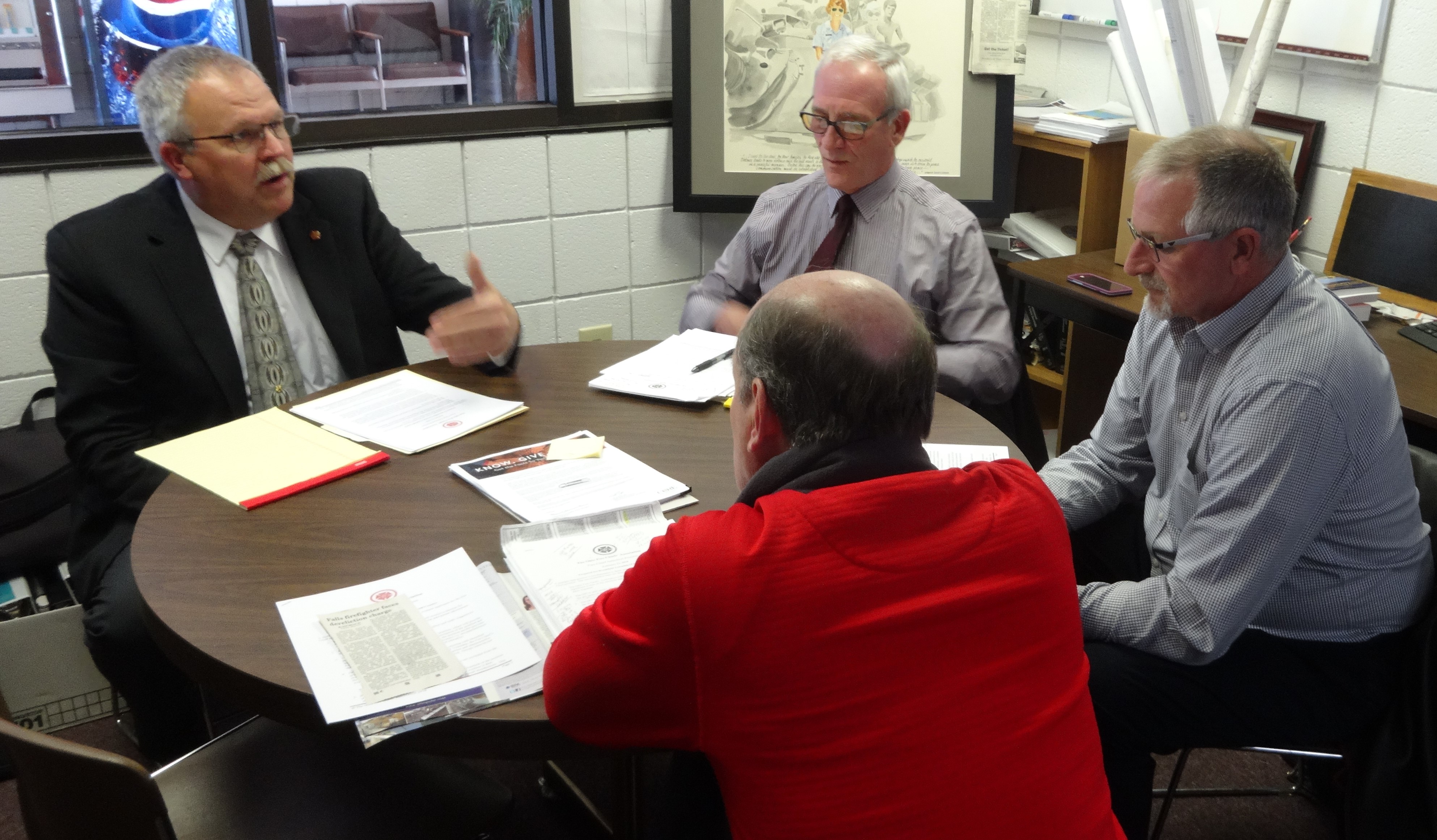 Mitch Ross of the Ohio Fire Chiefs Association, left, meets with Brookfield trustees, clockwise from his left, Dan Suttles, Ron Haun and Gary Lees.