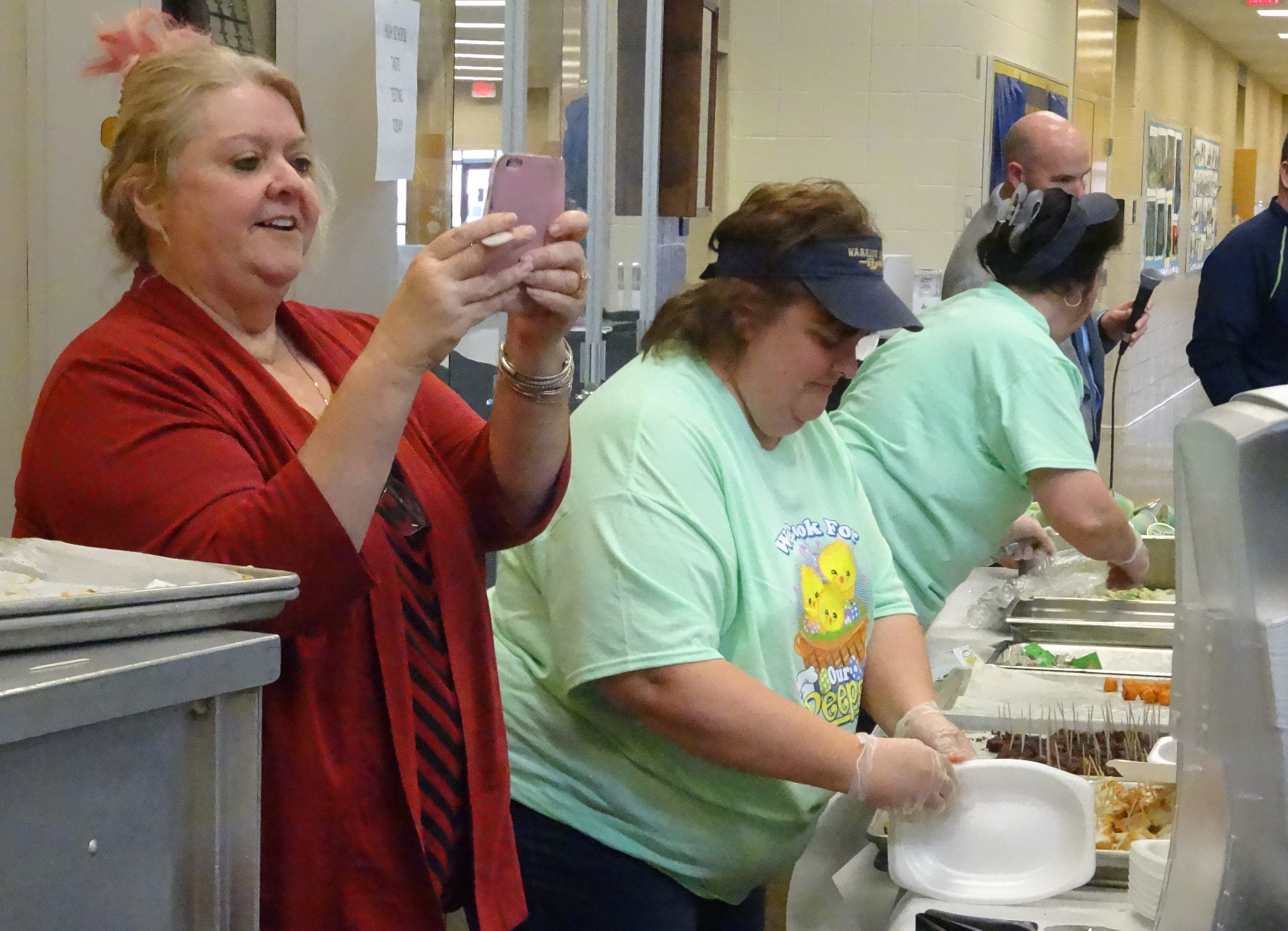 Brookfield Cafeteria Supervisor Donna Bailey takes pictures of students falling in line for a taste test of potential new lunch offerings. Also shown are Kim Osberg and Leanne Mosora.