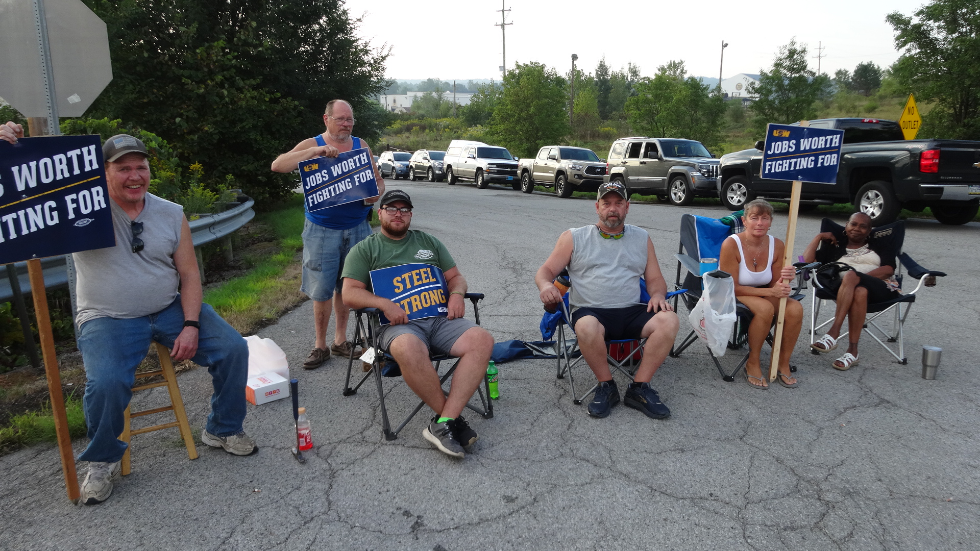 Bill Fragle of Hermitage, a former Roemer Industries employee, shown standing, supports current employees who are, from left, Richard Ellison of Sharpsville, Matthew Mulligan of Brookfield, Kurt Wedge of Burghill, Therese Smith of West Middlesex and Sandra Evans of Youngstown.
