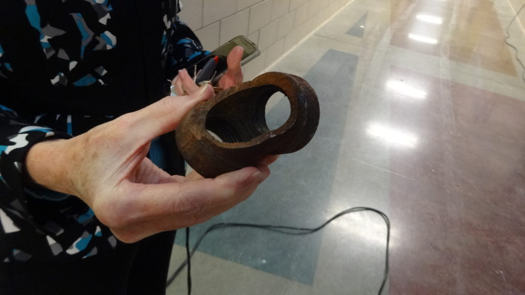 Brookfield school Superintendent Velina Jo Taylor holds the water pipe elbow that blew out in the elementary school.