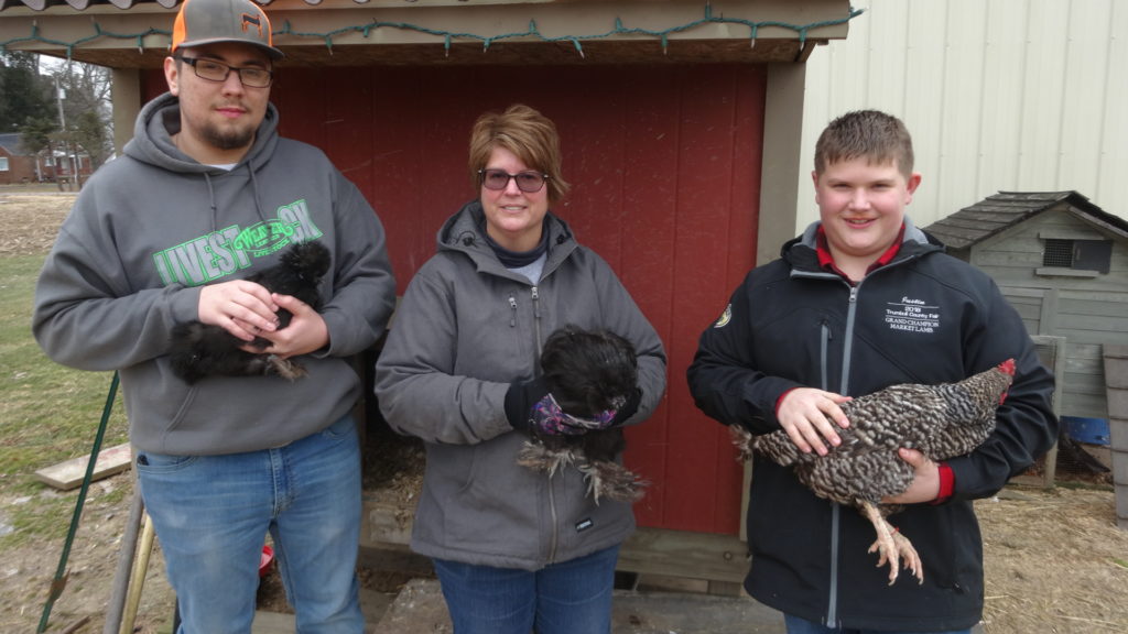 4-H member Blake Yendrek holds Lola, a blue silkie chicken, Brenda Hall, a 4-H adviser, holds Mr. Mann, a blue silkie rooster named after Brookfield Police Cpl. Ron Mann, and Hall's son, Justin Hall, holds Princess, a barred rock chicken.