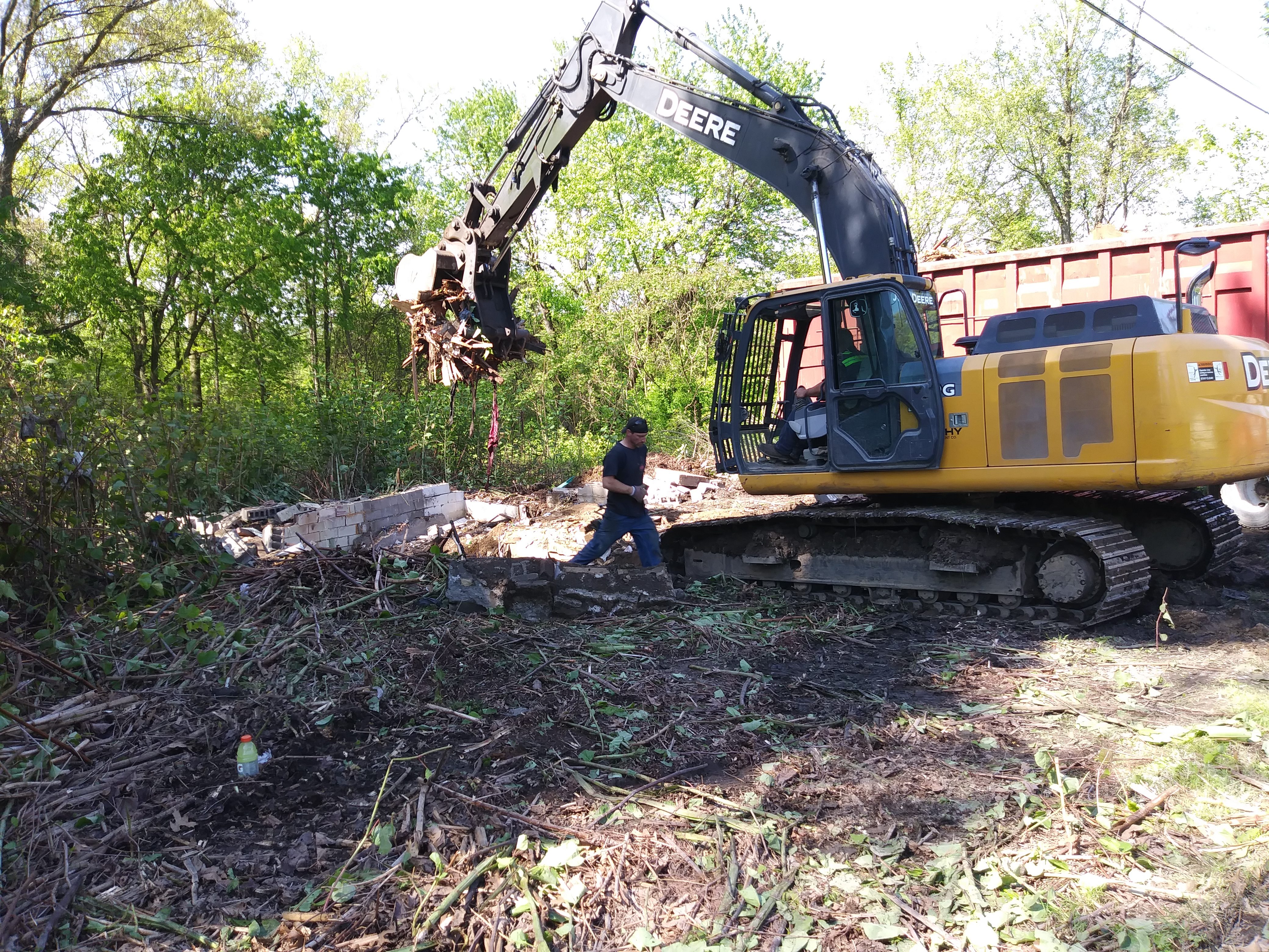 Ryan Sereday is at wheel of excavator; Sereday laborer Chad Richmond helps out on the ground.