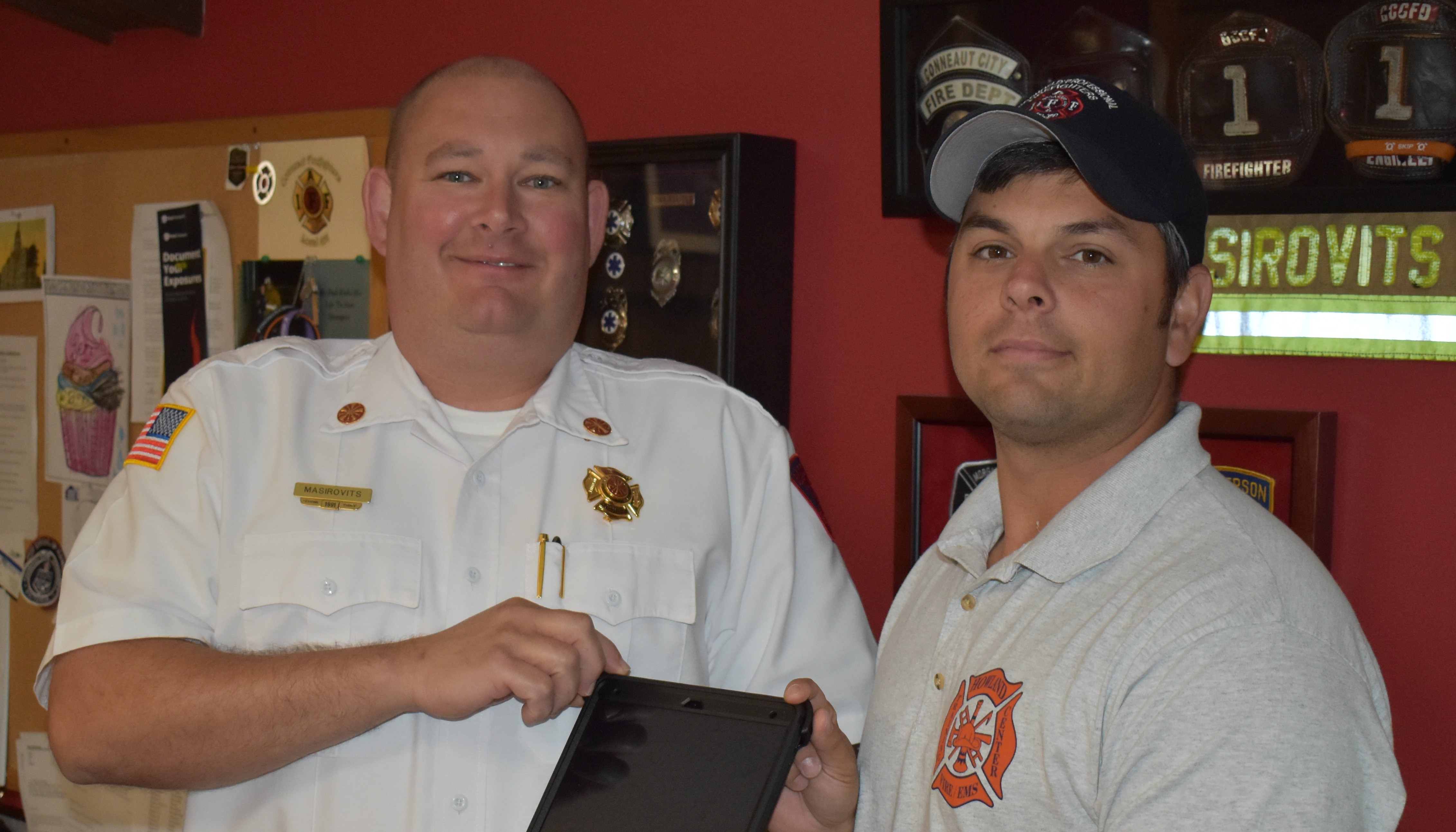 Brookfield Fire Chief David Masirovits, left, and Capt. Nick Cresanto show one of Apple iPad Pros the department received in a grant award.