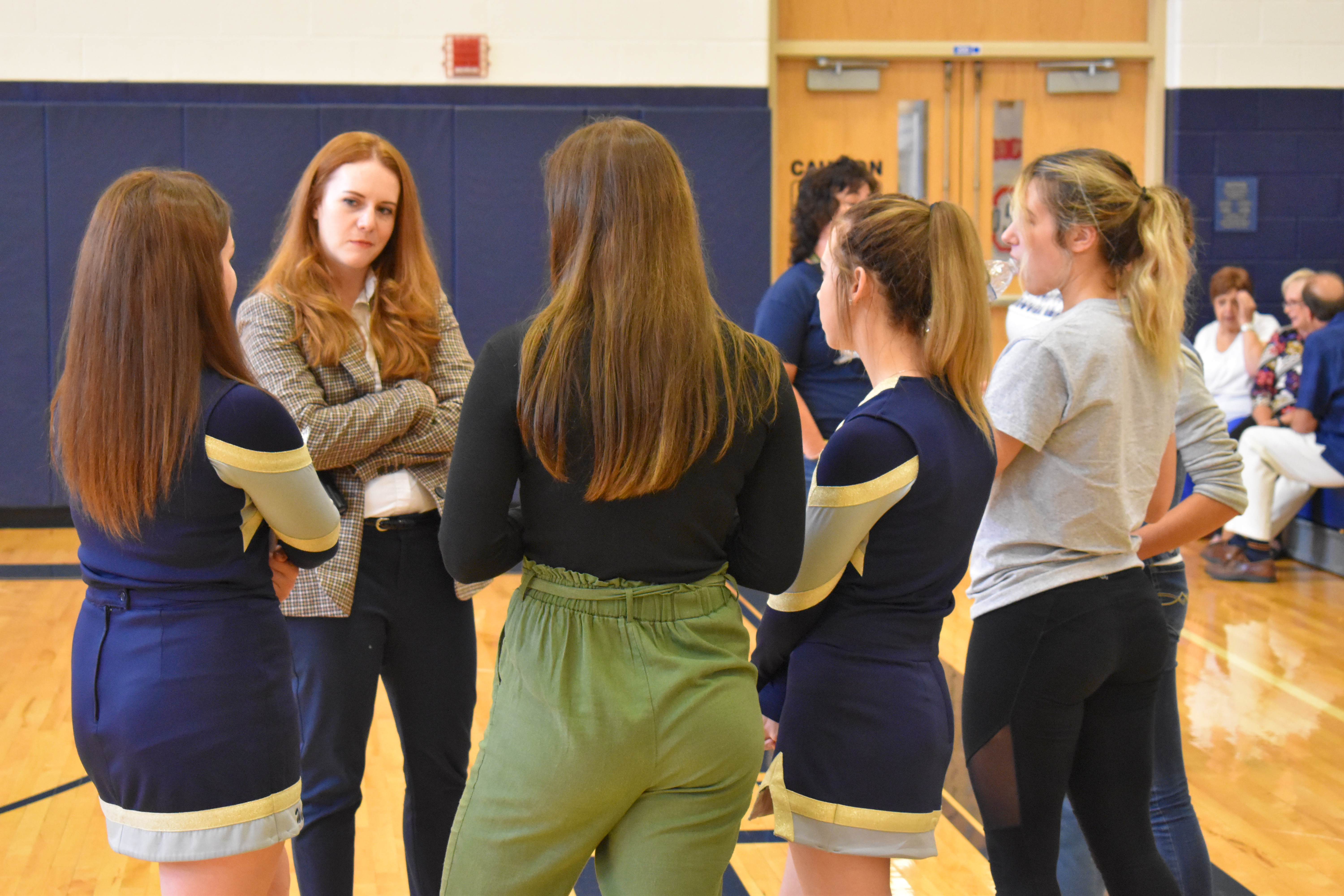 Elizabeth Drummond, second from left, listens to Brookfield High School girls following her presentation on surviving in male-dominated fields