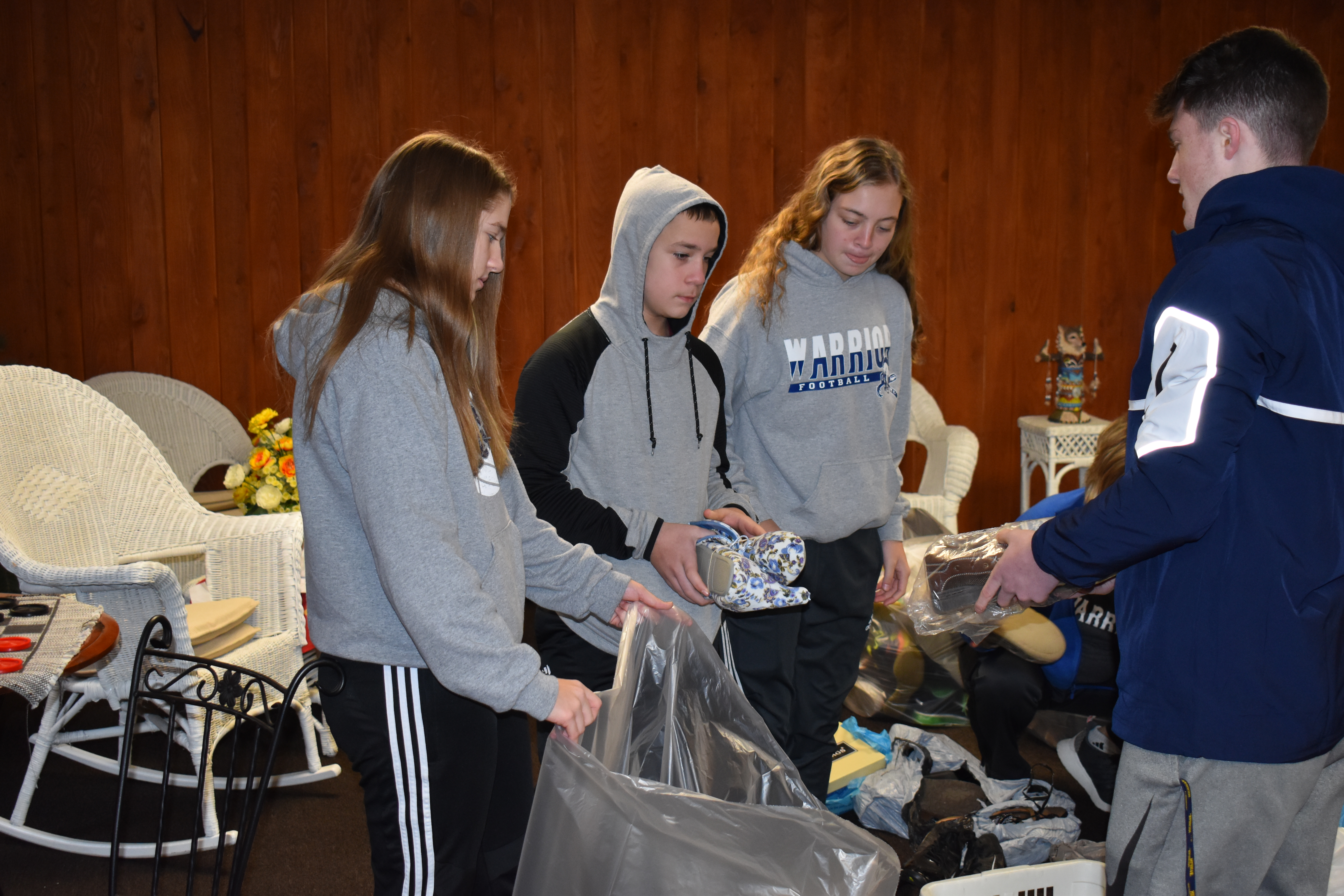 Brookfield basketball players, from left, Anna Reichart, Bryan Reardon, Audrey Reardon and Haden Gibson package shoes donated to a Brookfield Basketball Parents fundraiser.