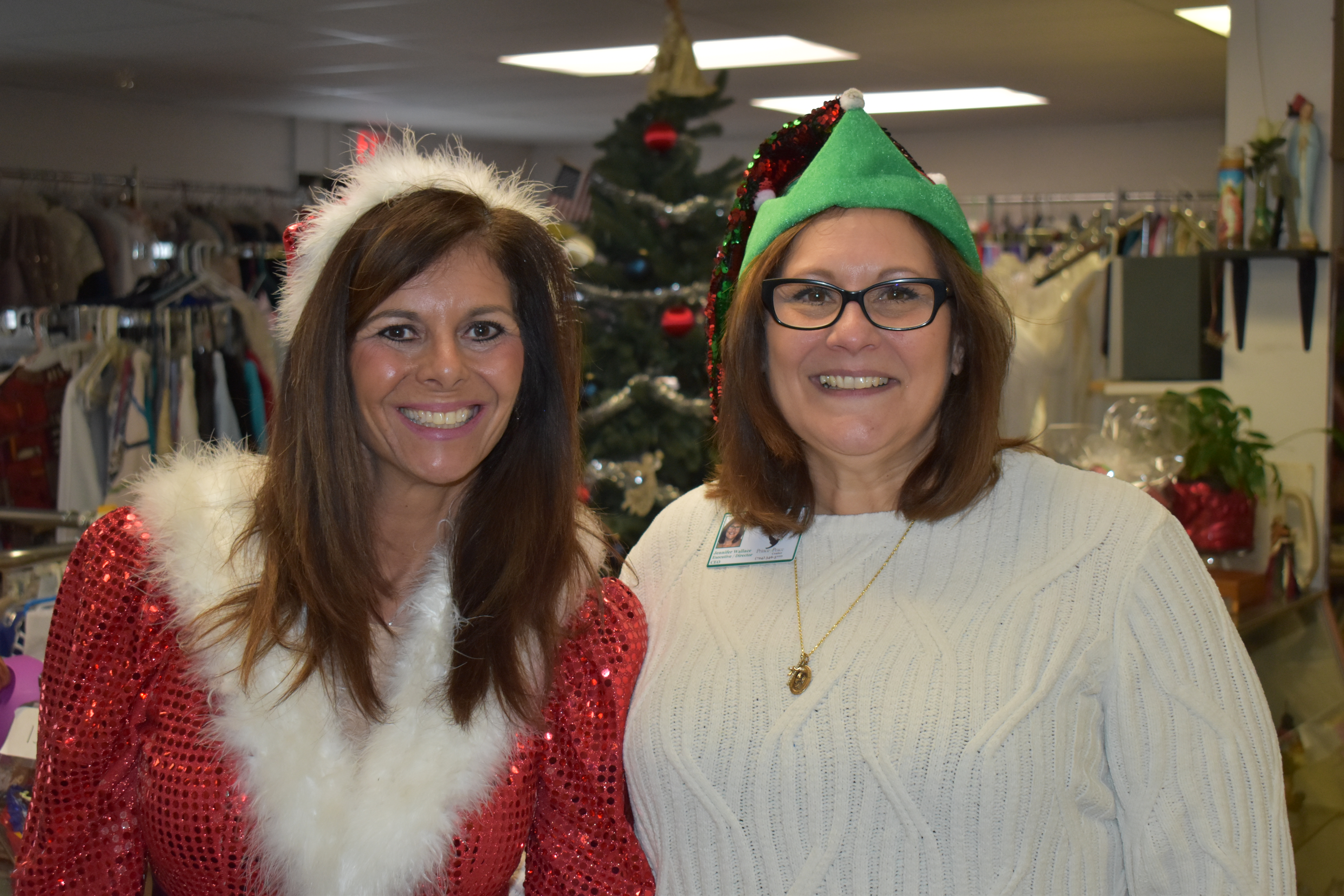 Prince of Peace Center, Farrell, Executive Director Jennifer Wallace, right, and Community Supportive Service Director Natalie Higbee, left, are shown in Christmas costumes for the center's toy giveaway.