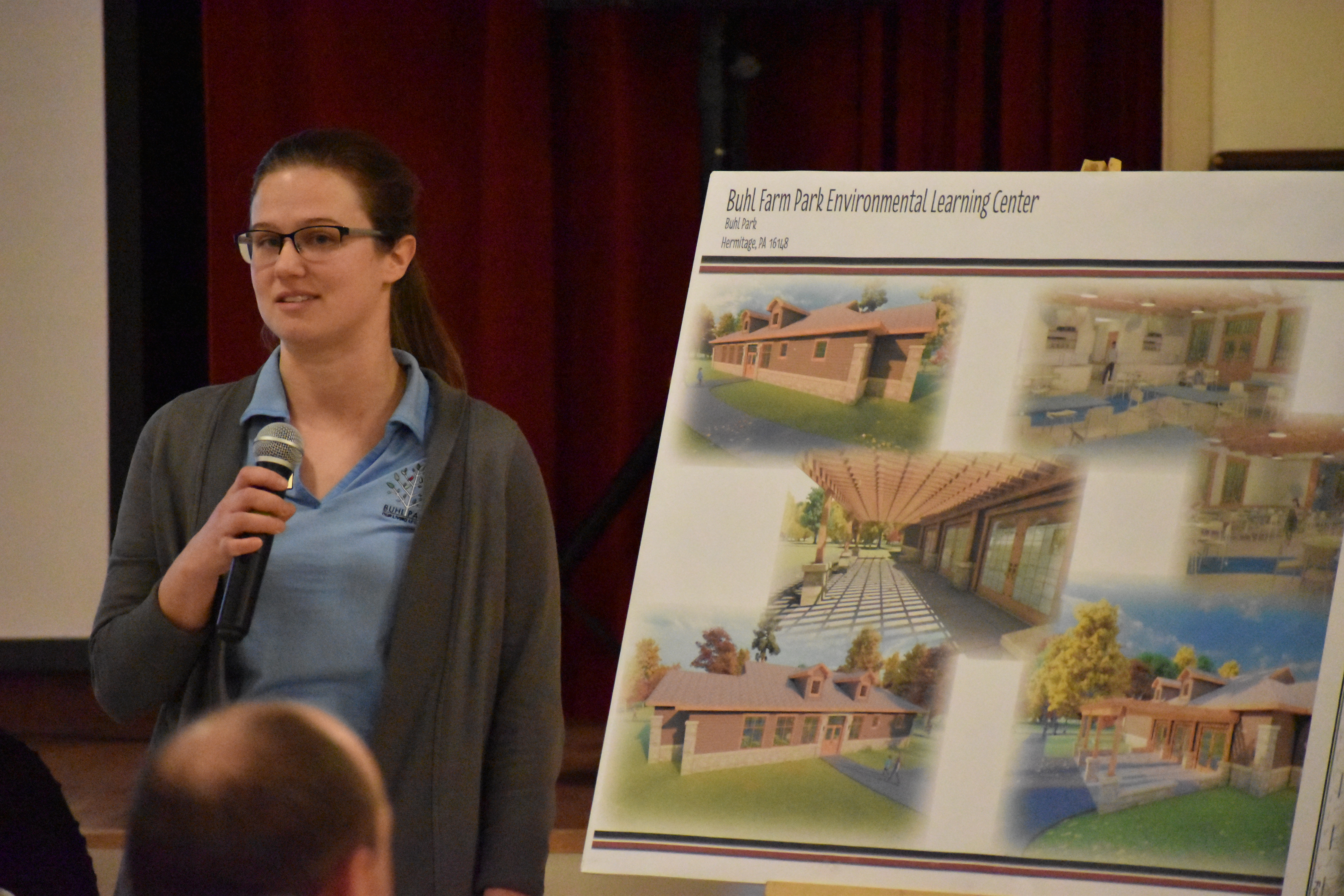 Katie Nowland, Buhl Park's environmental education director, stands with an artist's rendering of the education center that officials at the Hermitage park want to build.