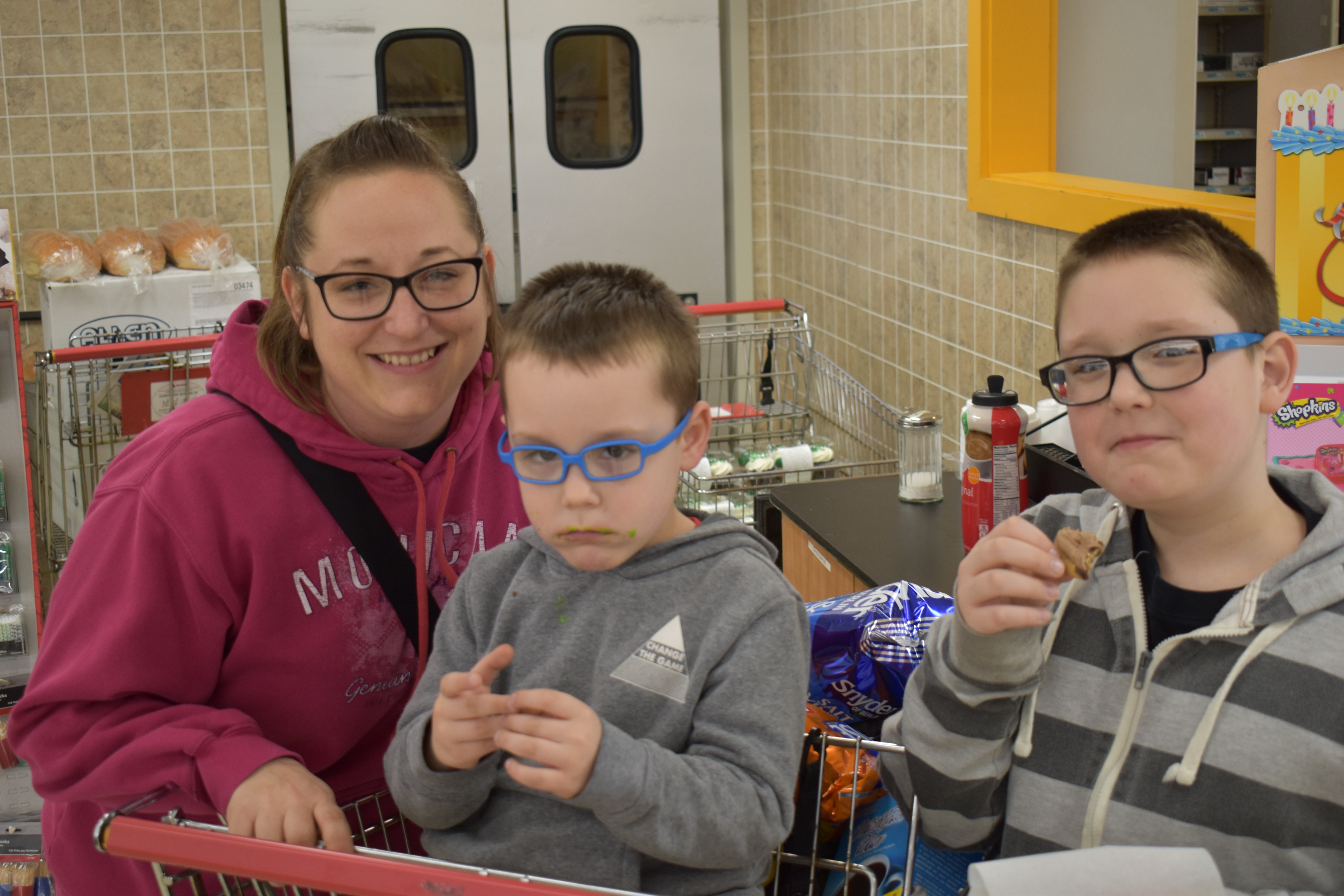 Carli Brant and her sons, Owen, center, and Carter, who are enjoying cookies at Sparkle Market, Brookfield.