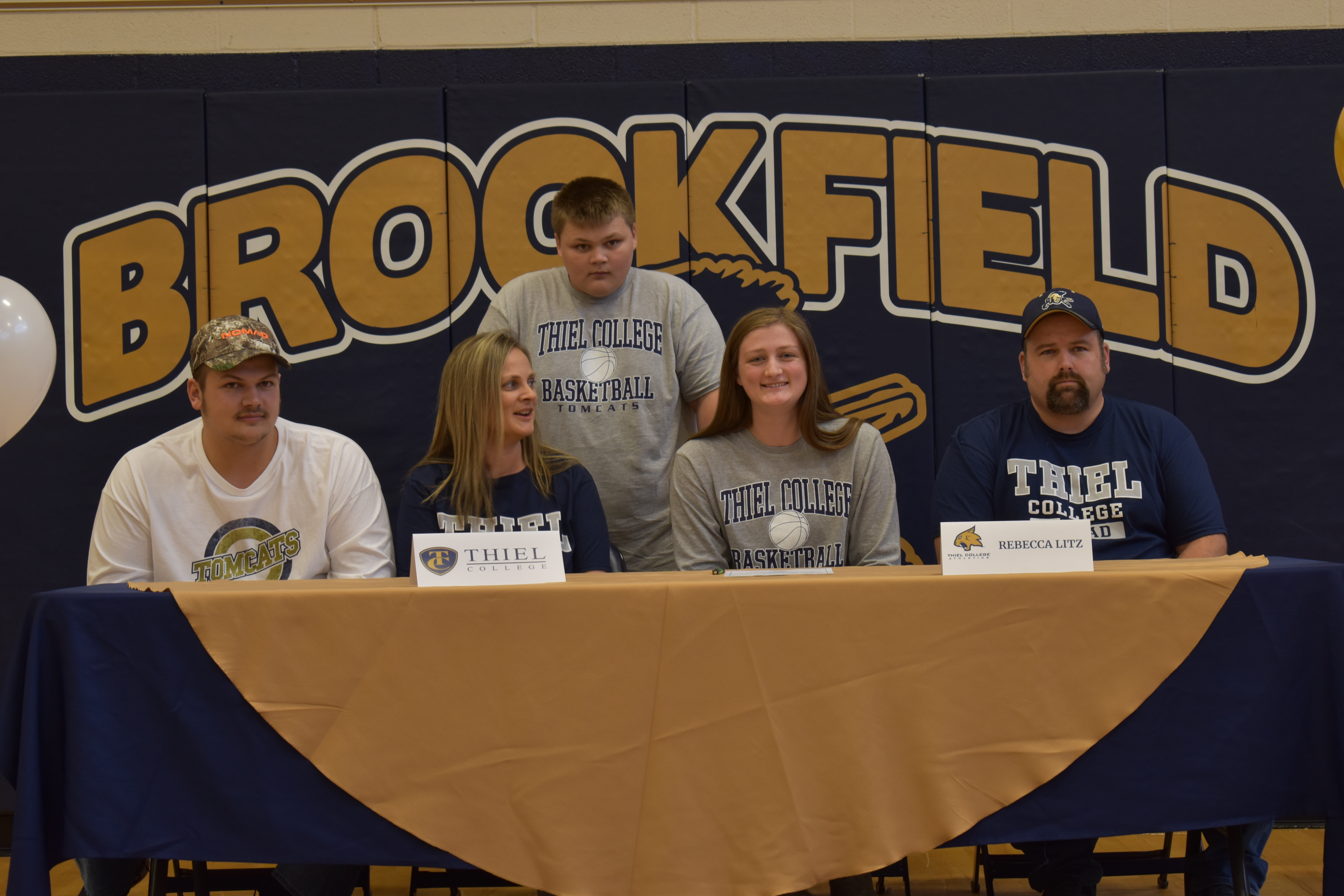 Rebecca Litz is shown with her mom, Kim; her dad, Brad, at right; and her brothers, Bailey, left, and Bradyn, after she signed to play college basketball at Thiel College in Greenville.