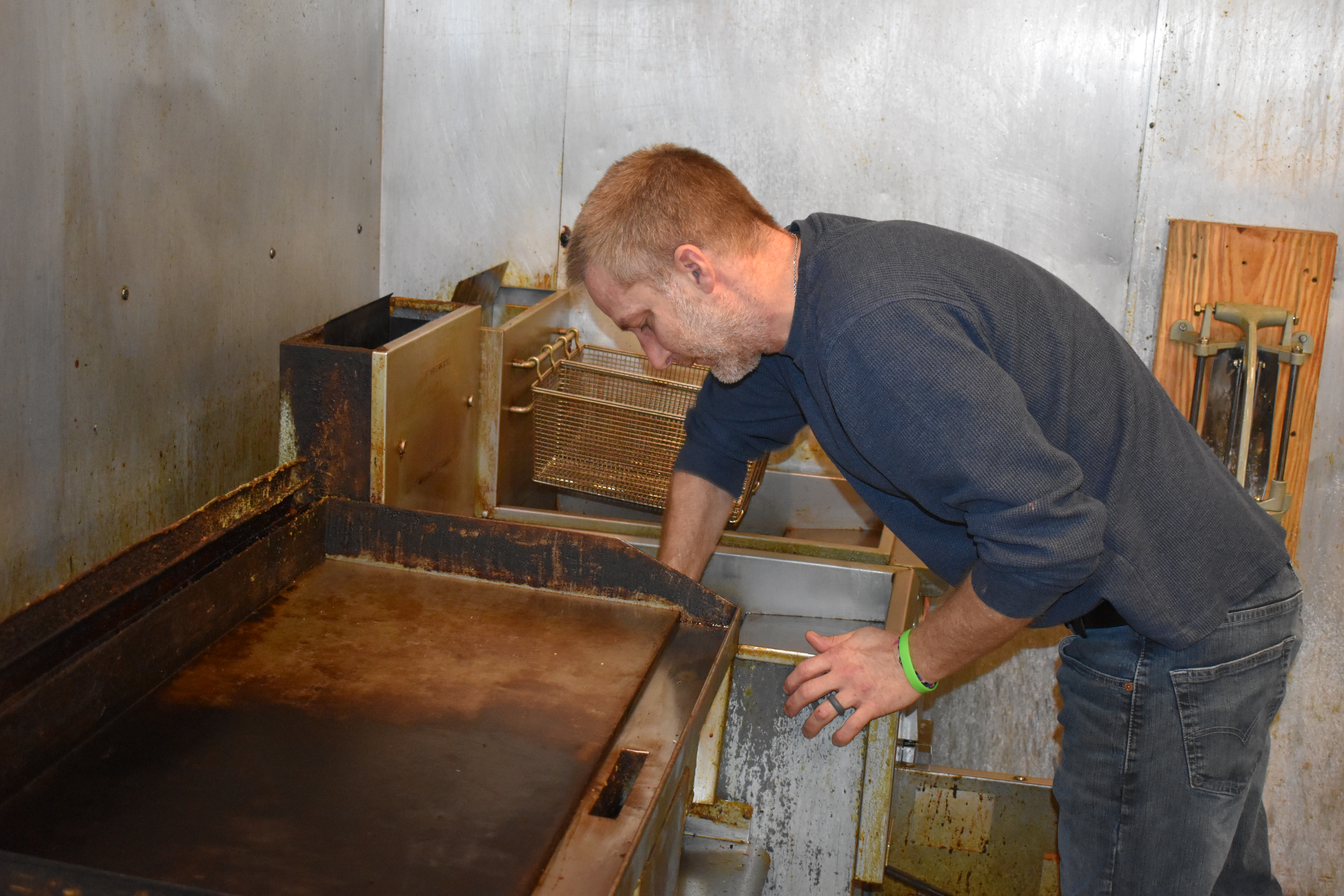 Dave Driscoll scrubs the fryer at R.P. McMurphy's Sports Bar and Grill, Masury.