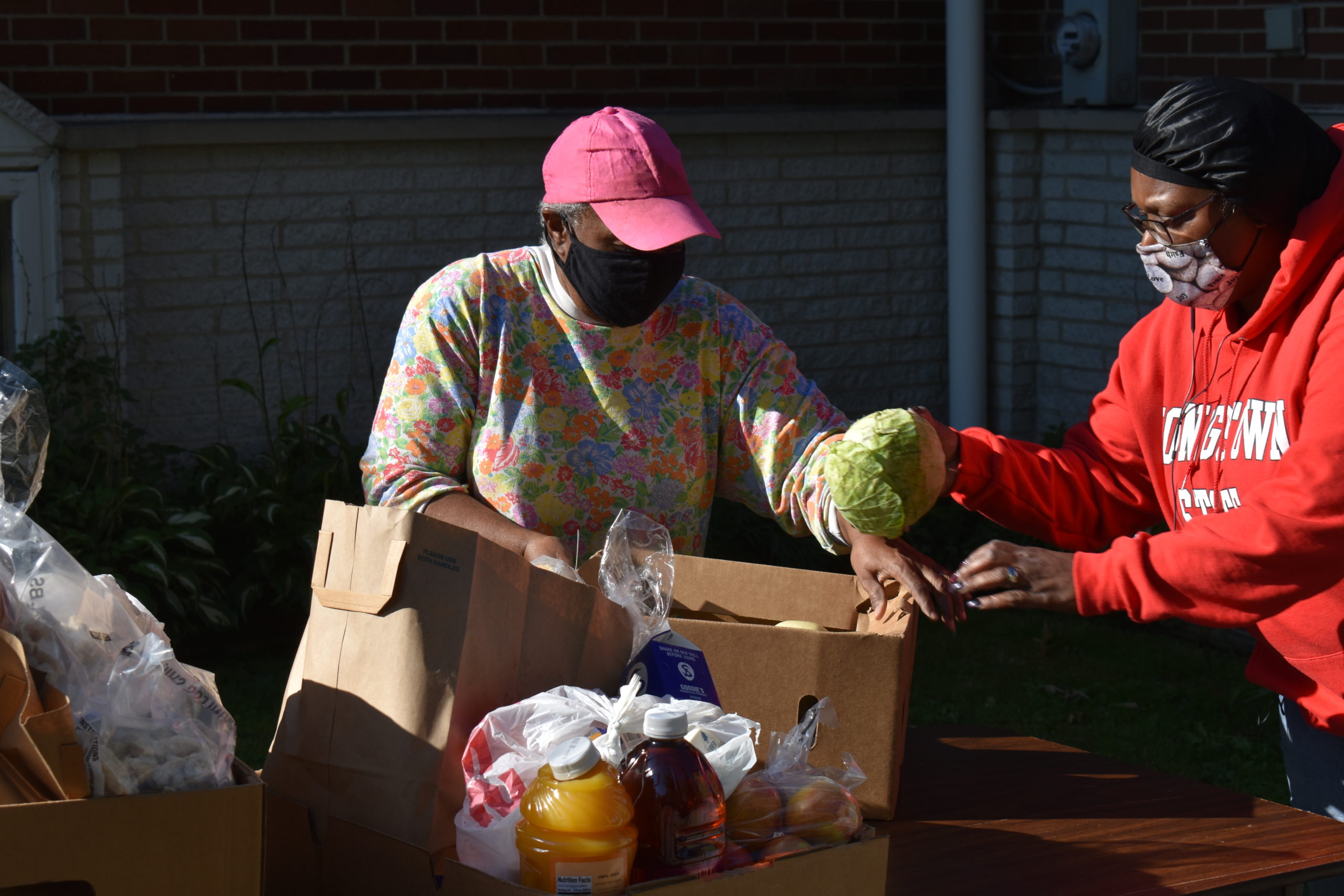 Creola Snow, left, and Veronica Peavy prepare a food box at the Mount Olive pantry on Sept. 19.