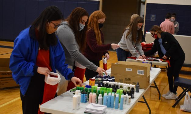 Students stuff stockings for overseas military
