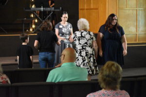 The Rev. Abby Auman collects keys to Six-Fourteen Church from congregants at the church's last service. The congregation has disbanded.