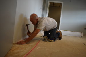 Tom Brodie of Brodie Construction nails down tack strip as part of the carpet installation at the new Brookfield Board of Education office. Renovations of the former bank building on Bedford Road were included in the $368,000 purchase price.