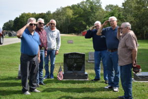 Charles Dobbins' Army brothers salute him at Dobbins' grave in Brookfield Township Cemetery. They are, from left, Gary Eagle, Lloyd Eggleston, Dave Brooker, Bill Ehrsam, Robert Elza and Louis Fejes. Judi Swogger/NEWS On the Green photo.