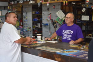 Greg Tesoriero, right, reminisces with life-long friend Wally Sinkuc on the last day of operation for Tony's Auto Parts in Masury, the business begun by Tesoriero's father.