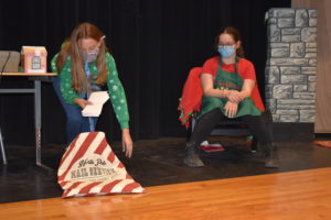 Ava Winters, left, draws letters to Mrs. Claus, Kaylin Poggi, right, from the North Pole mailbag in “Dear Mrs. Claus,” a Brookfield Drama Club play that will be performed at Warrior WinterFest on Nov. 20.