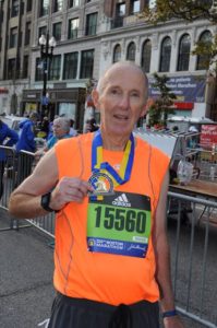 Tim Taylor displays the Boston Athletic Association medal he received for finishing the Boston Marathon.