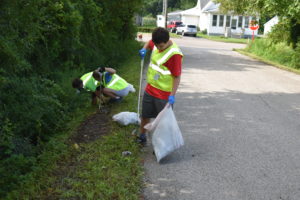 Sam Plyler, foreground, and Sami and Billy McAnany participated in Brookfield Township's first neighborhood cleanup in August.