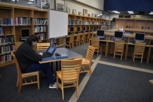 Gavin Clark studies in the Brookfield high school-middle school library, which could become the home for the Maker Space and STEM equipment.