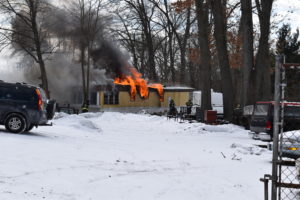 Brookfield firefighters battle a mobile home fire Feb. 19 on Boyd Street. The home was destroyed, and the occupant received second-degree fires from a fire believed to have begun by unattended cooking, firefighters said.
