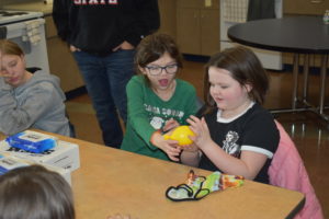 Evelyn Richman, left, and Amara Mason handle a frozen balloon as part of their study of the states of matter at the afterschool program run by Youngstown State University at Brookfield Elementary School.