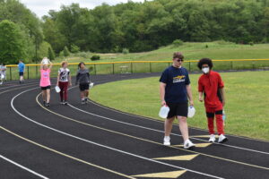 Brookfield Middle School students carry jugs of water to highlight water scarcity.