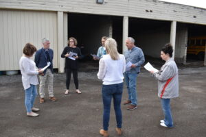 Brookfield Supt. Toby Gibson, second from left, and Treasurer Julie Sloan, third from left, discuss the condition of the school bus garage with school board members, from left, Ronda Bonekovic, Derek Mihalcin, Sarah Kurpe, Jerry Necastro and Melissa Sydlowski.