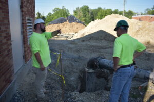 Cameron Deem, left, answers a question from Scott Verner at the Brookfield Wastewater Treatment Plant.