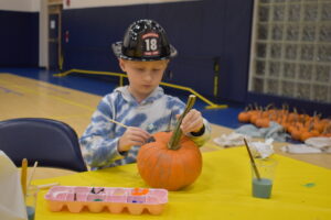 Dominic Saffle paints a pumpkin at Brookfield Safety Awareness Night, which was held at the Brookfield Local School District building.
