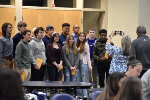 Brookfield High School Principal Megan Marino takes a photo of the letter winners from the cross-country team.