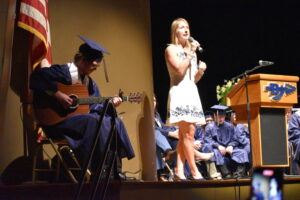 Senior Emanual Knoxville, on guitar, and teacher Miriam Necastro performed Carole King's "You've Got a Friend" at graduation.