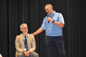 Distinguished Alumni Hall of Fame inductees Jason Straka, right, and Toby Gibson are shown at a school assembly.