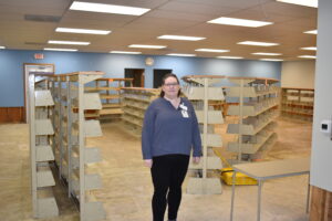 Brookfield Branch Library Manager Amanda Murphy stands in the empty library, where water from broken water pipes had spread throughout the building. Plans are underway to renovate the building and eliminate the threat of future pipe problems.