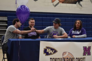 David Pawlowski, left, congratulates his brother, Donovan, who committed to play football at the University of Mount Union.