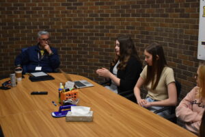 Eighth-grader Aeryn Berena, second from left, explains to school Supt. Toby Gibson, left, the advantages of having a permanent SPEAR-IT shop at the school. Kaylee Glover is at right and Emmalynn Jarvi also is shown.