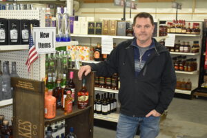 Dan O'Brien shows off his liquor stock at Yankee Lake Party Center, which he now operates.