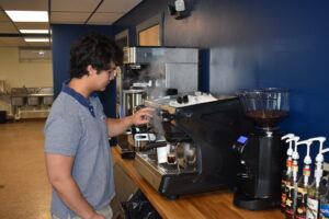 Matthew Chu prepares a cup of espresso at Old 82 Brew, his new coffee shop next to Belly Buster Sub Shop.