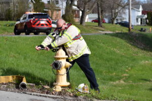 Brookfield Fire Chief David Masirovits opens a hydrant at the scene of a car fire in 2020.