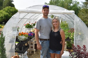 Chad Roper and Emily Dye stand in front of the greenhouse of Brookfield Supply. The landscaping supply yard opened recently at 1336 Route 7, Brookfield.