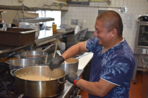 Ivan Ponce mixes up a batch of rice at La Palma Family Restaurant, which recently opened in Brookfield.