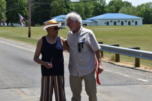 Pauline Walker Phillips and Bob Good, siblings of soldiers killed in Vietnam, embrace after cutting the ribbon renaming a bridge on Warren Sharon Road as Vietnam Veterans Memorial Bridge.