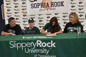 Sophia Hook signs a letter of intent to play basketball at Slippery Rock University. With her are her parents, Ronald “Skeeter” and Stacy Hook, and brother, Joe.