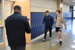 Blake Hammond, right and Alex Higbee walk the halls of Brookfield Middle School as Chris Kilroy films them for a music video