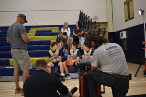 Alex Higbee, with basketball, and friends are shown during the shoot for a video, “I Like a Girl.”