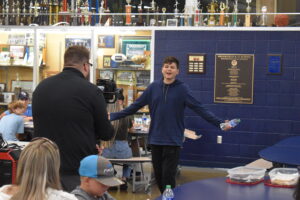 Alex Higbee sings “I Like a Girl” in the Brookfield school cafeteria as videographer Chris Kilroy shoots footage for a music video.