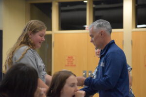 Brooke Montgomery receives her letter for girls track from Brookfield school Supt. Toby Gibson.