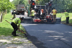 Youngblood Paving of Wampum, Pa., a subcontractor hired by Wilson Construction/Lindy Paving, paves Ulp Street, a road torn up by an Aqua Ohio waterline project.